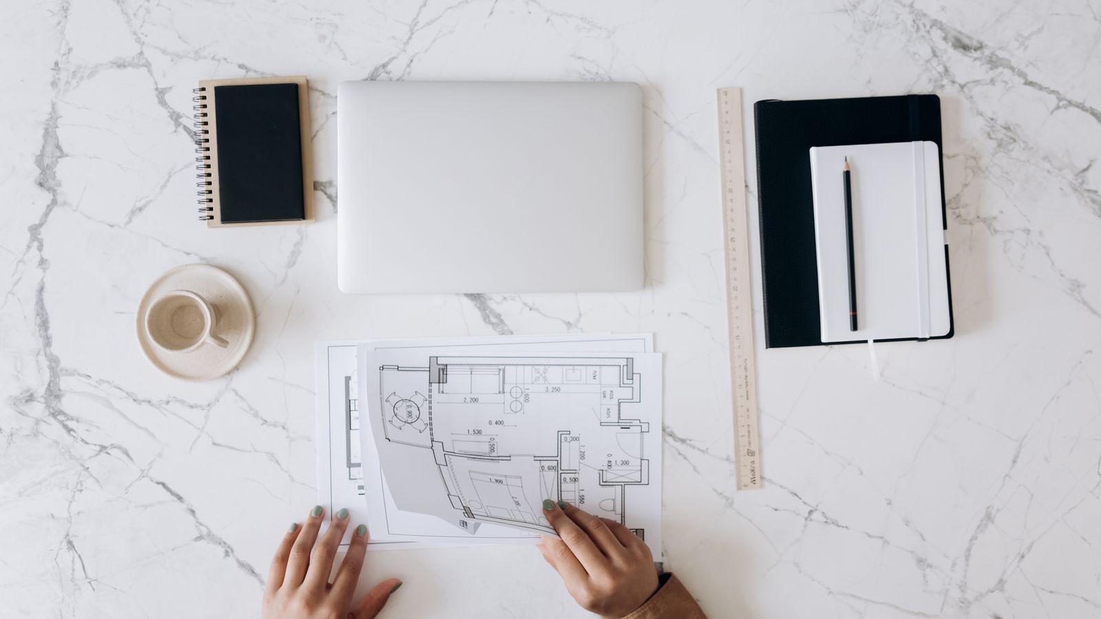 Blueprint papers and drafting tools on a work surface.